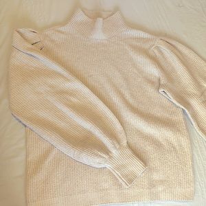 Light Tan, low turtleneck Sweater.